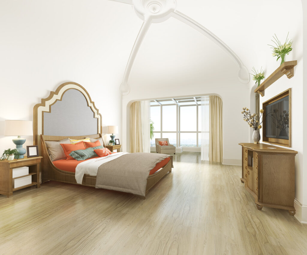 A modern, sparsely decorated bedroom with light wood floors.