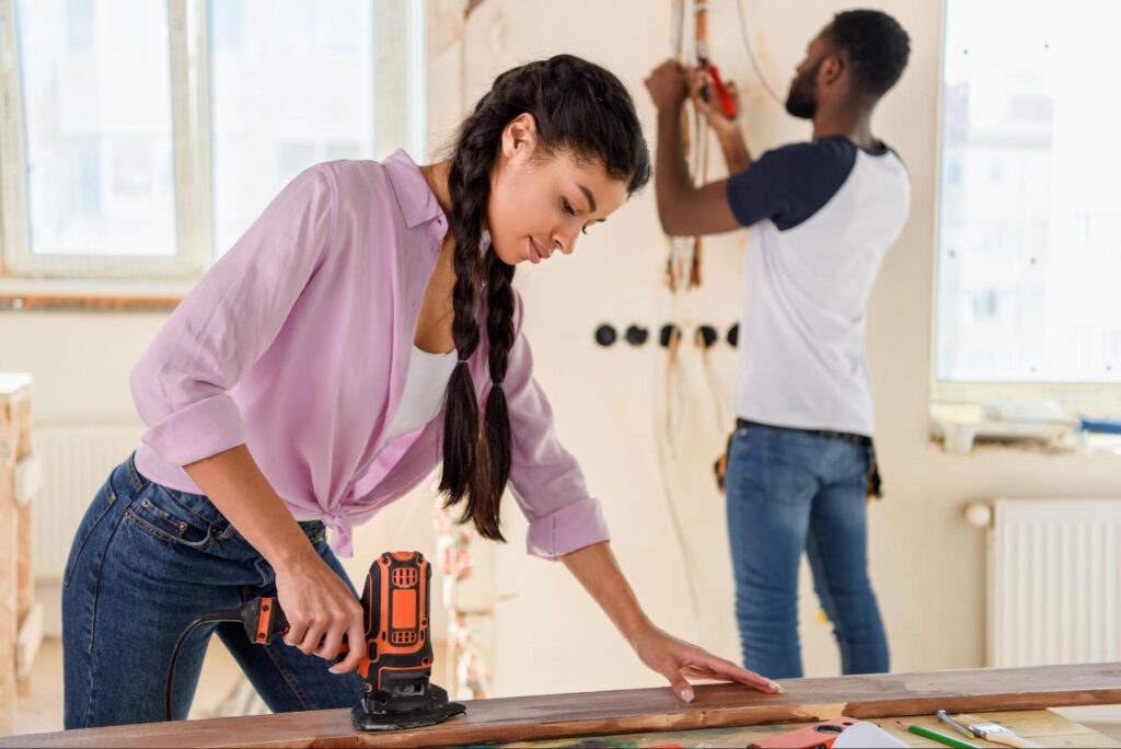 A man and a woman work together on a home improvement project.